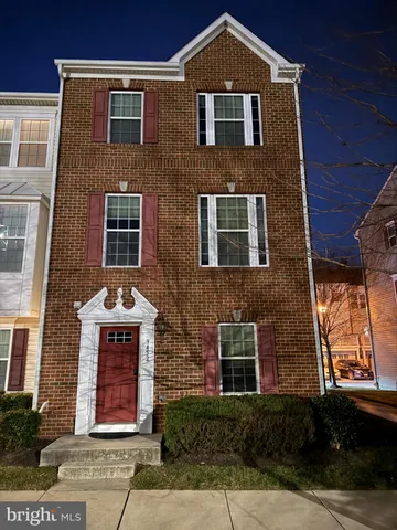 a front view of brick house with a yard