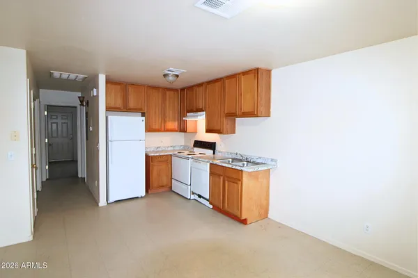 a kitchen with stainless steel appliances granite countertop a refrigerator a stove top oven a sink and dishwasher
