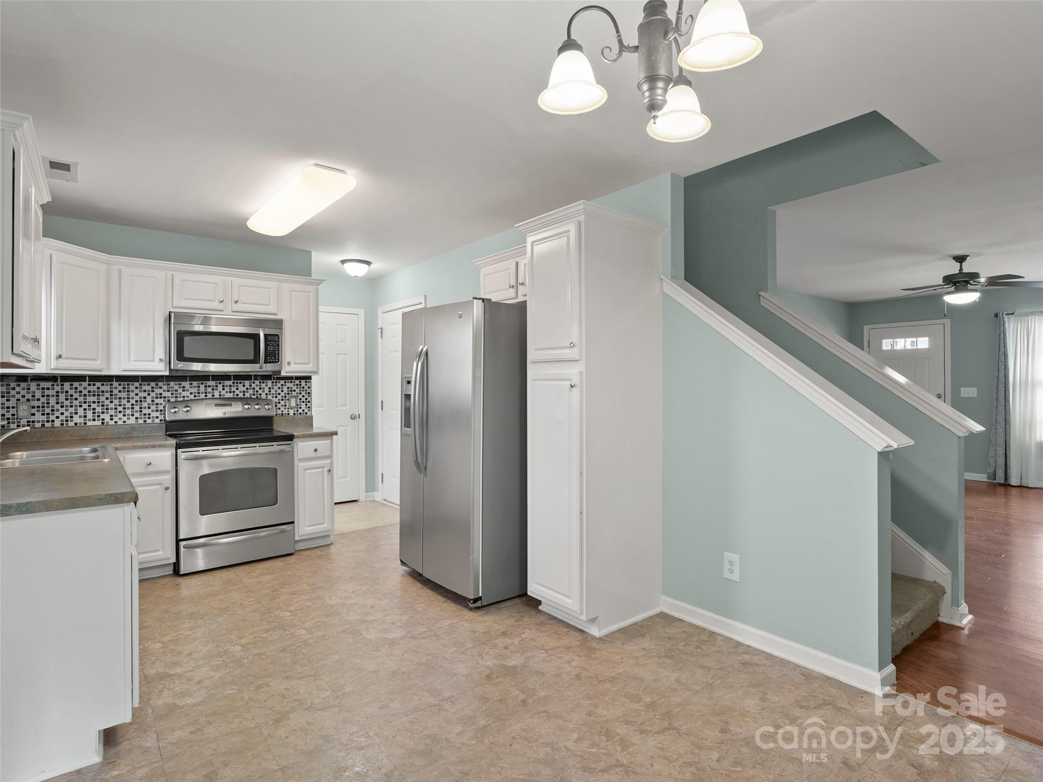 24 Torrington Avenue Fletcher, NC 28732 - Photo 9 of 32 a kitchen with a refrigerator and a stove top oven
