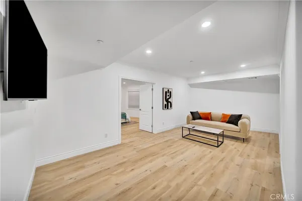a bedroom with a bed and painting on the wall