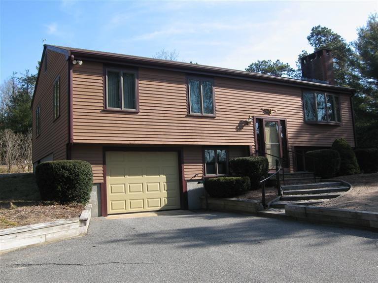 1800 South County Road Osterville, MA 02655 - Photo 1 of 17 a front view of a house with a garage