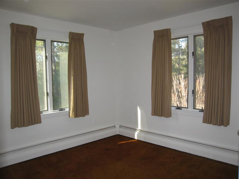 1800 South County Road Osterville, MA 02655 - Photo 9 of 17 an empty room with wooden floor and windows