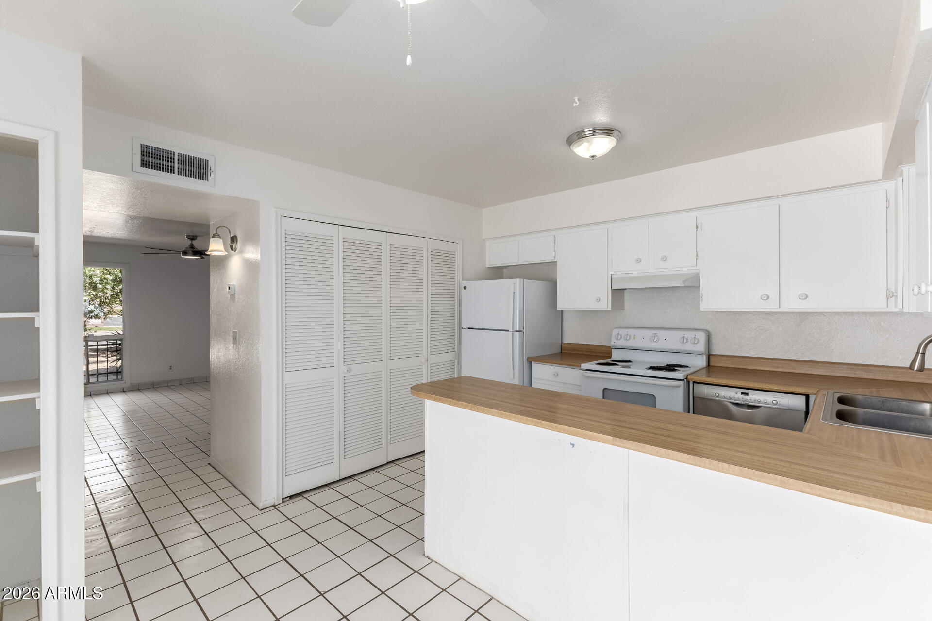 6348 North 7th Avenue, Unit 1 Phoenix, AZ 85013 - Photo 13 of 36 a kitchen with stainless steel appliances a refrigerator a sink a stove a microwave and cabinets