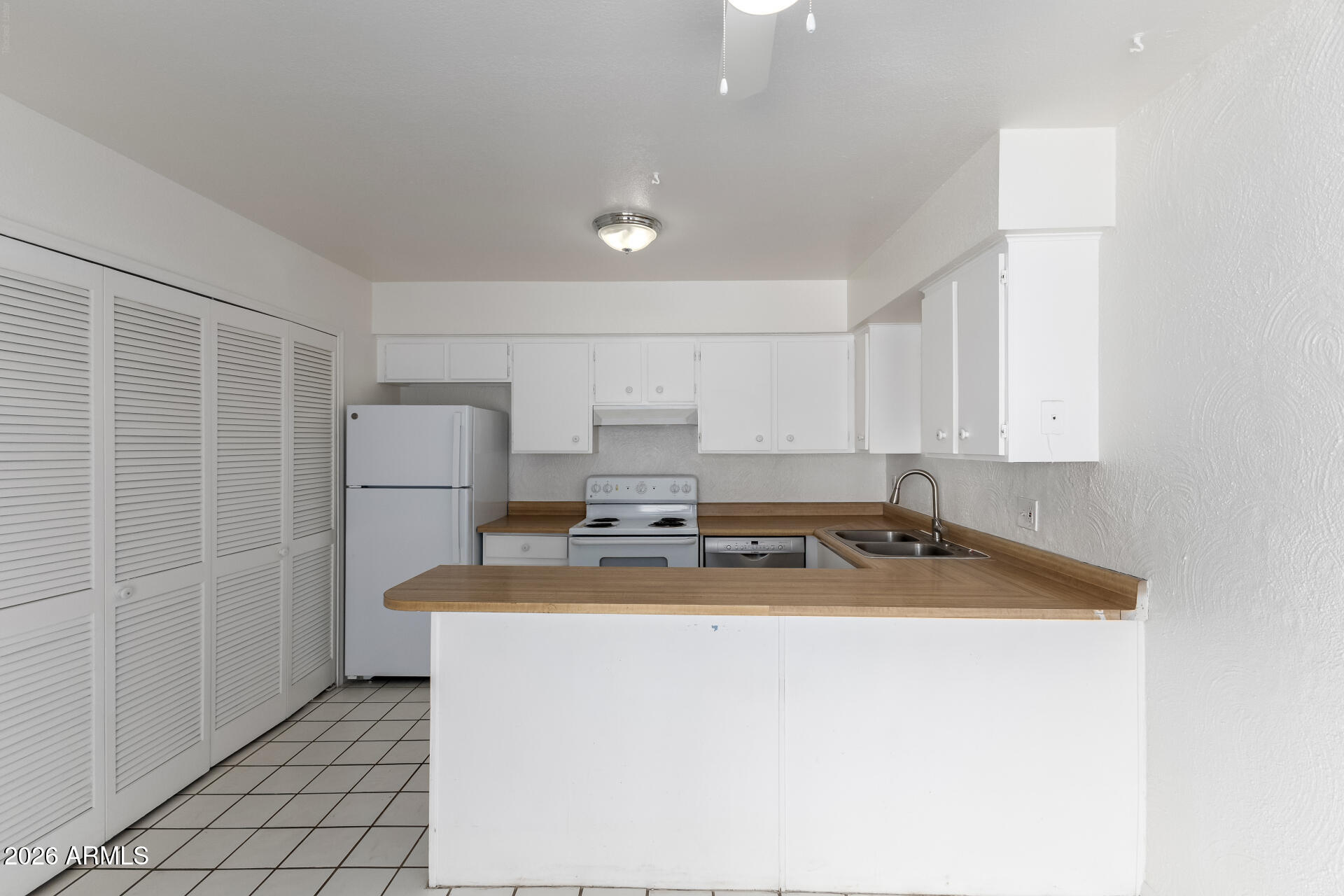 6348 North 7th Avenue, Unit 1 Phoenix, AZ 85013 - Photo 14 of 36 a kitchen with refrigerator and cabinets