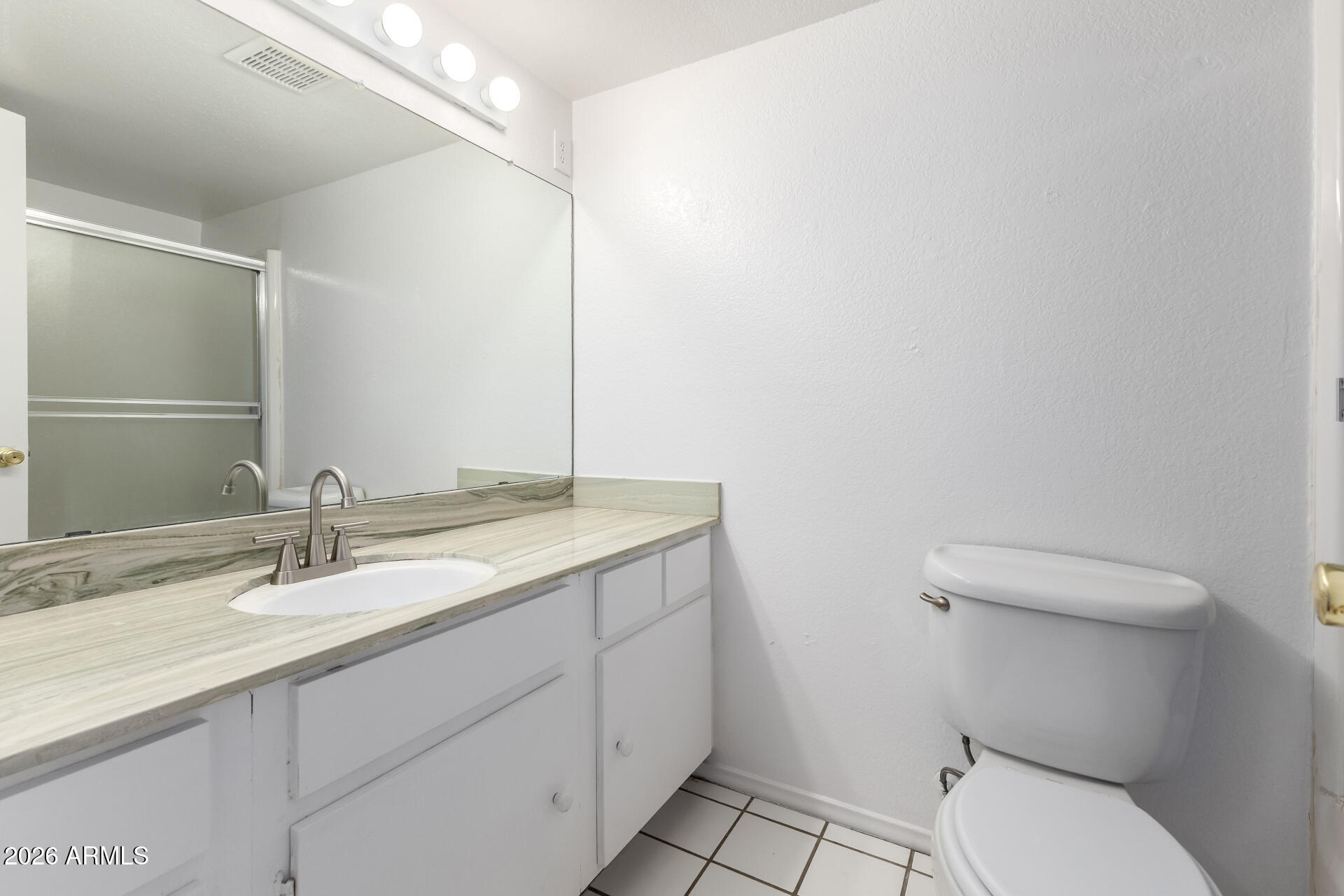 6348 North 7th Avenue, Unit 1 Phoenix, AZ 85013 - Photo 20 of 36 a bathroom with a granite countertop toilet sink and mirror