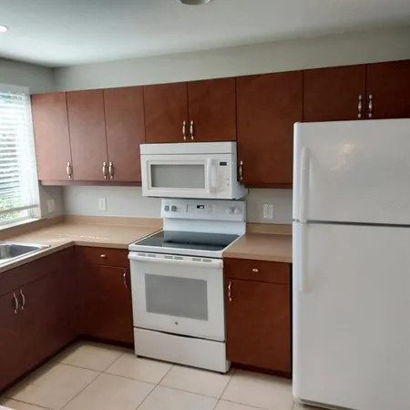 a kitchen with a stove sink and refrigerator