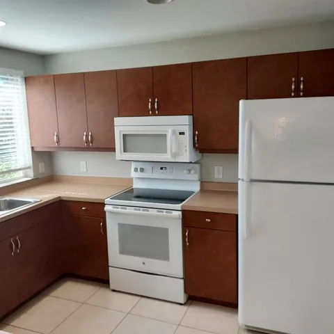 a kitchen with a stove sink and refrigerator