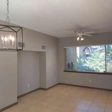 a view of room with window and open kitchen