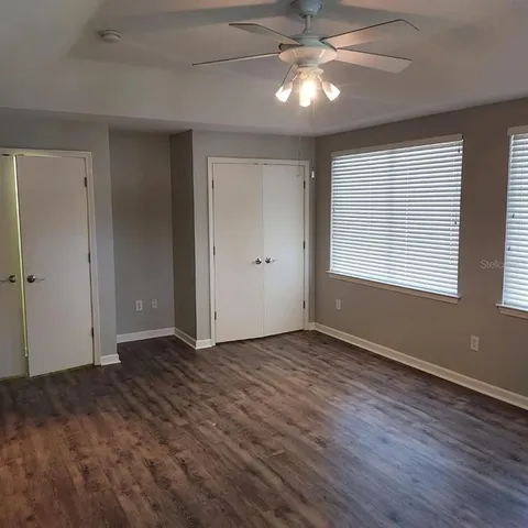 a bathroom with a granite countertop sink a toilet and a mirror