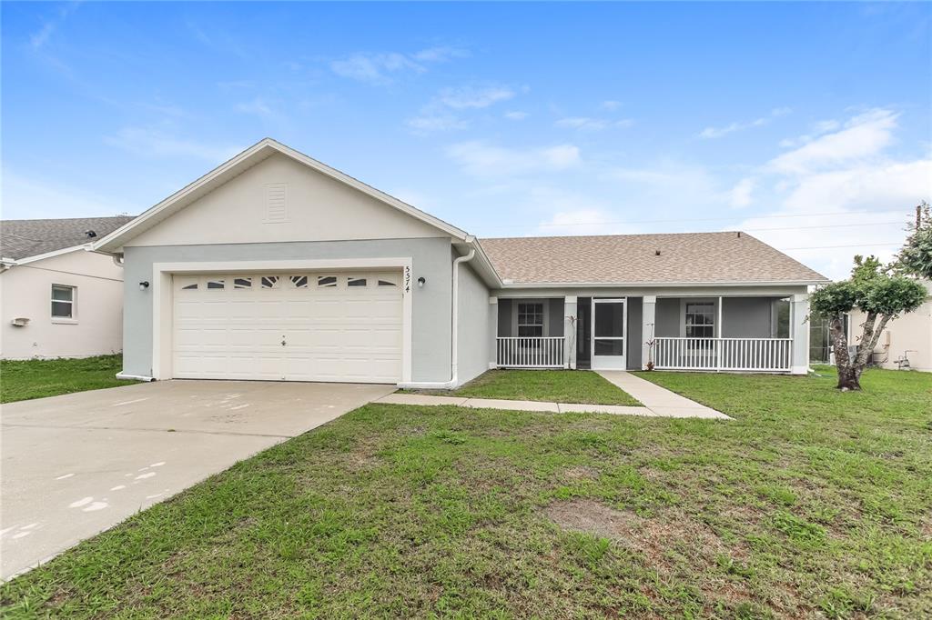 Undisclosed Address Kissimmee, FL 34758 - Photo 1 of 1 a front view of a house with a yard