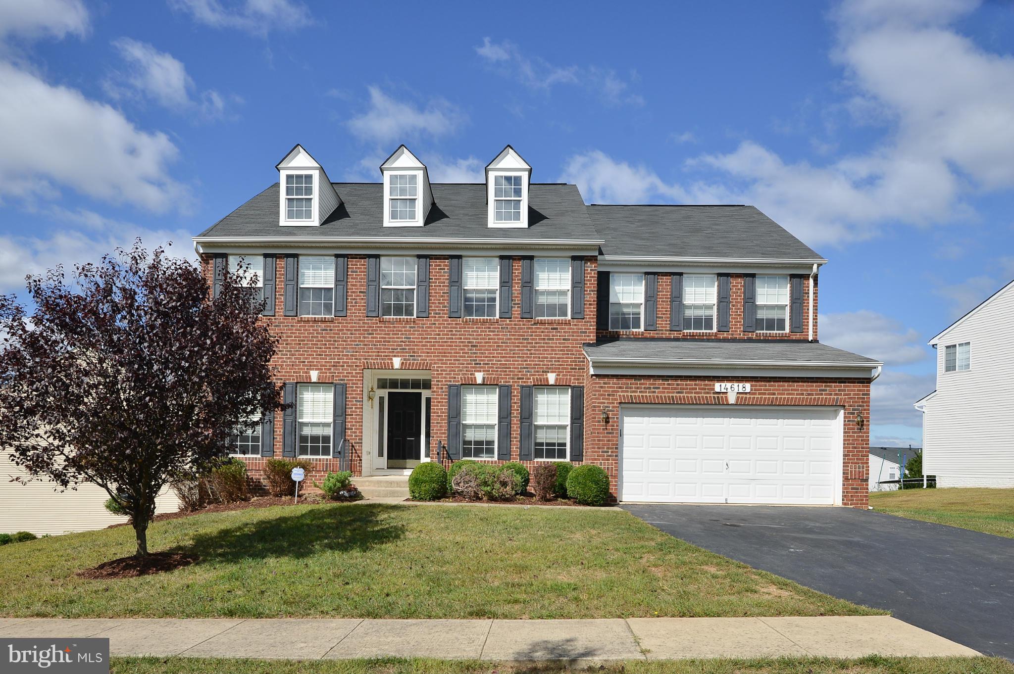 14618 Bubbling Spring Road Boyds, MD 20841 - Photo 1 of 26 a front view of a house with a yard