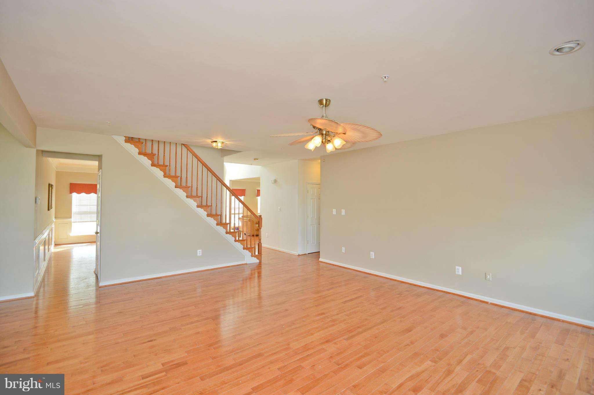14618 Bubbling Spring Road Boyds, MD 20841 - Photo 3 of 26 a view of an empty room with wooden floor and a chandelier