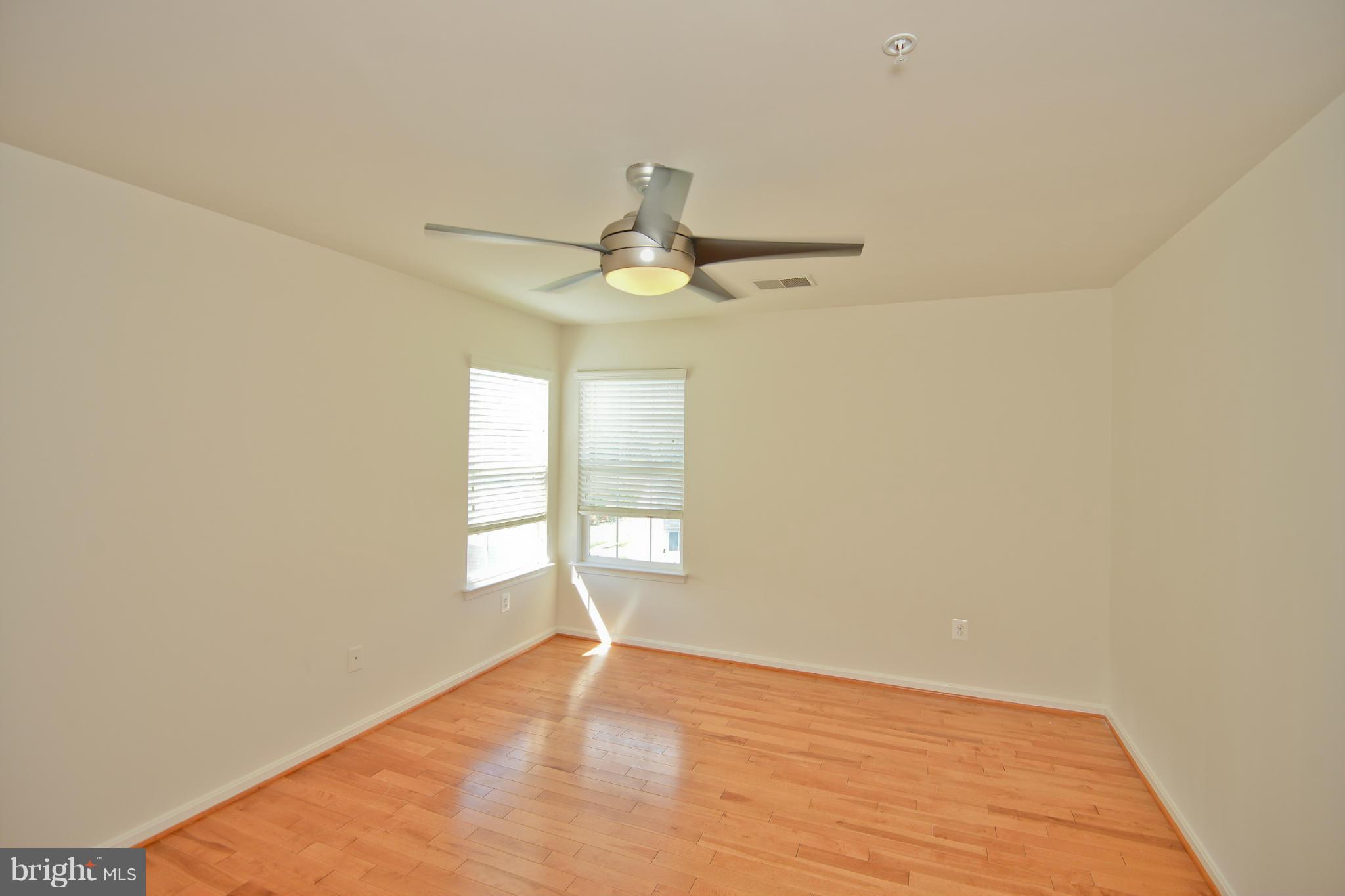 14618 Bubbling Spring Road Boyds, MD 20841 - Photo 22 of 26 an empty room with a window and a ceiling fan