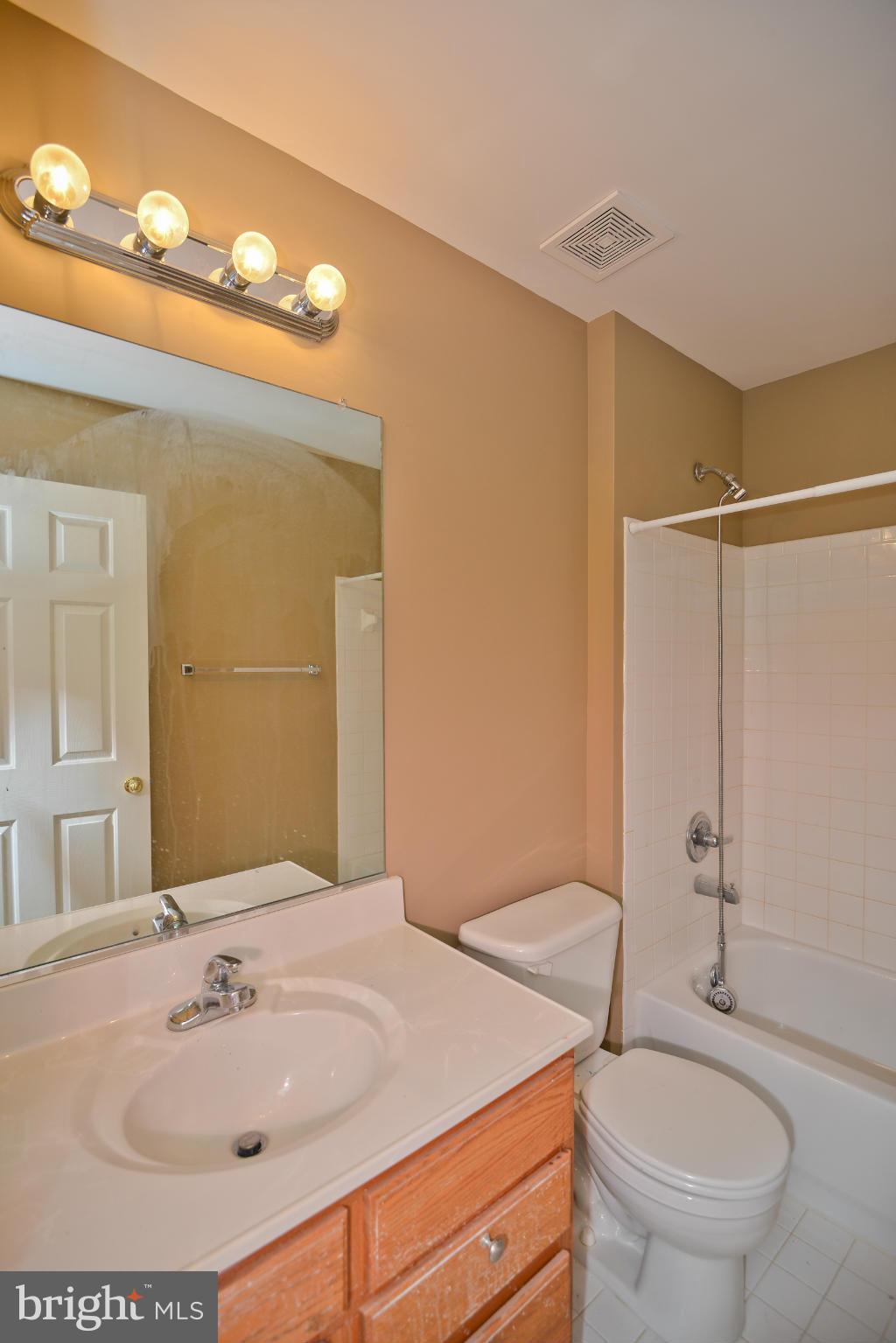 14618 Bubbling Spring Road Boyds, MD 20841 - Photo 23 of 26 a bathroom with a sink a toilet and shower