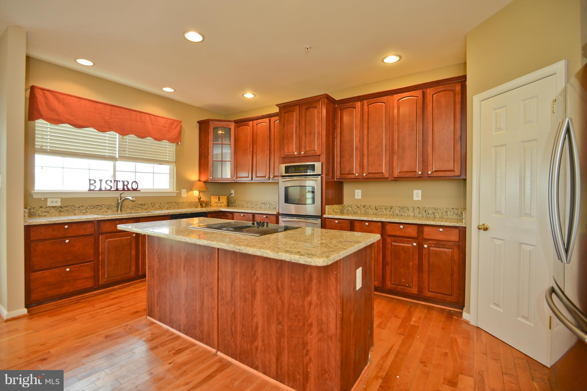 14618 Bubbling Spring Road Boyds, MD 20841 - Photo 9 of 26 a large kitchen with stainless steel appliances granite countertop a sink and a stove