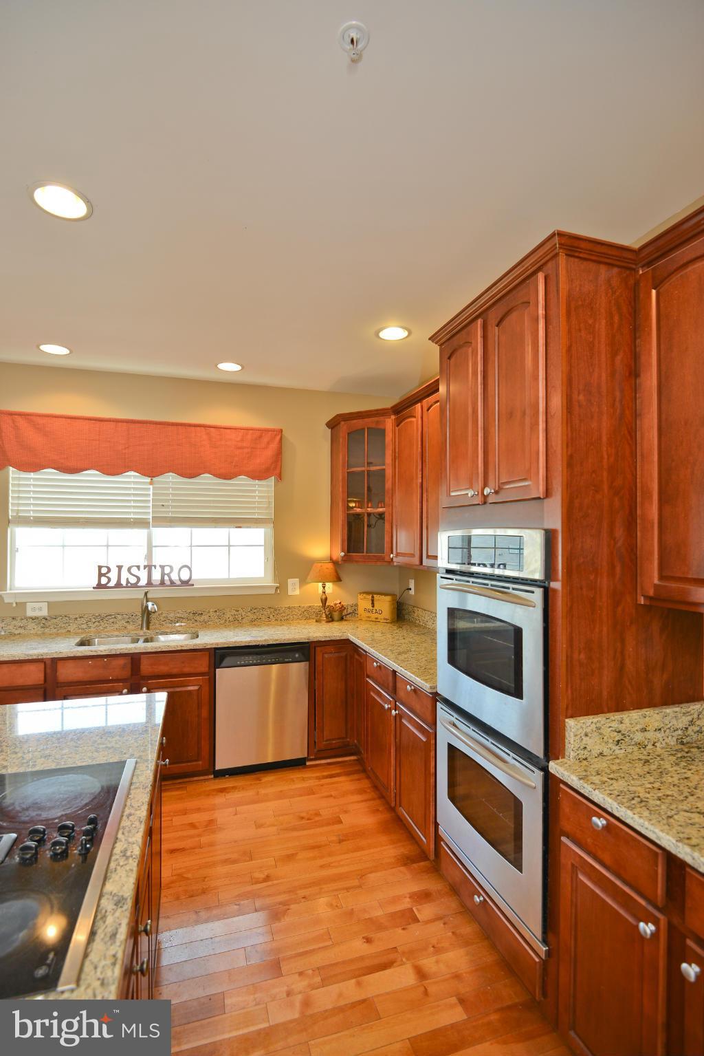 14618 Bubbling Spring Road Boyds, MD 20841 - Photo 10 of 26 a kitchen with a sink stove and cabinets