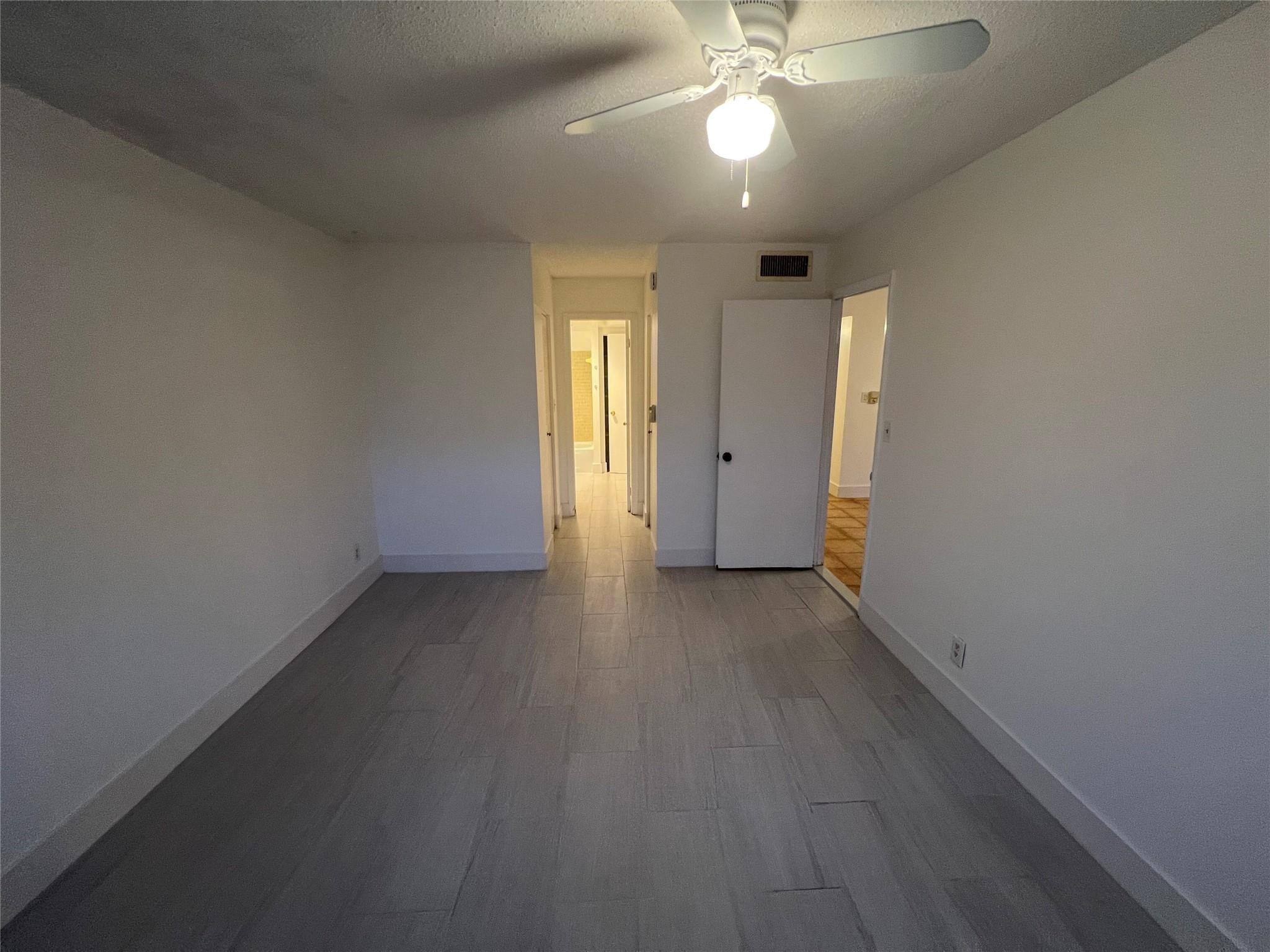 Undisclosed Address Dania Beach, FL 33004 - Photo 5 of 8 a view of a livingroom with a ceiling fan and window