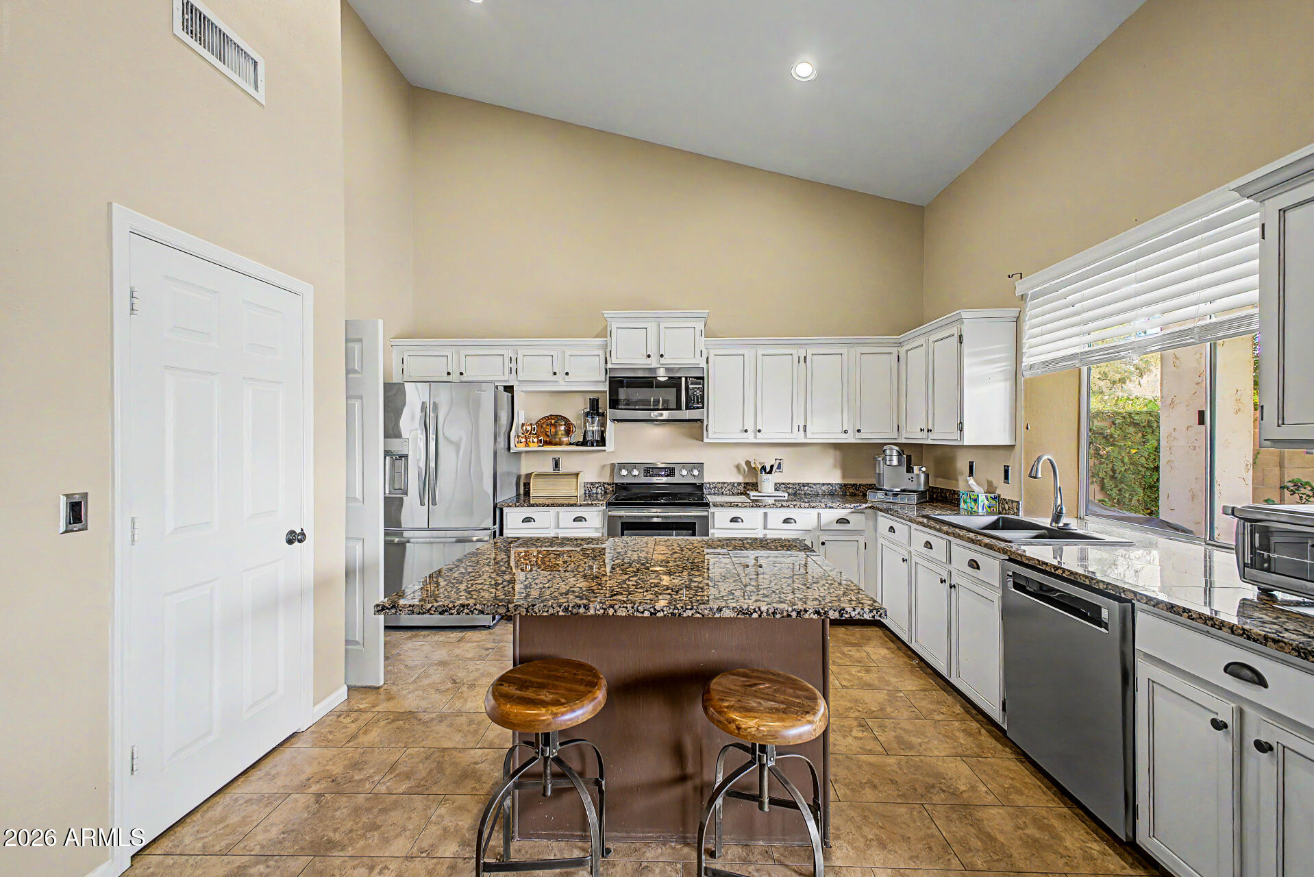 4309 East Rancho Caliente Drive Cave Creek, AZ 85331 - Photo 11 of 37 a kitchen with refrigerator and cabinets