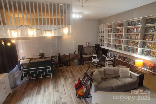 a living room with furniture a piano and a potted plant