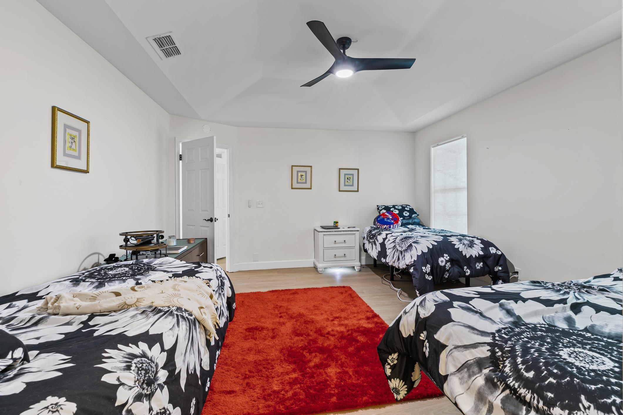 11511 Mandarin Road Jacksonville, FL 32223 - Photo 21 of 41 Bedroom featuring light wood-style flooring, a raised ceiling, and a ceiling fan