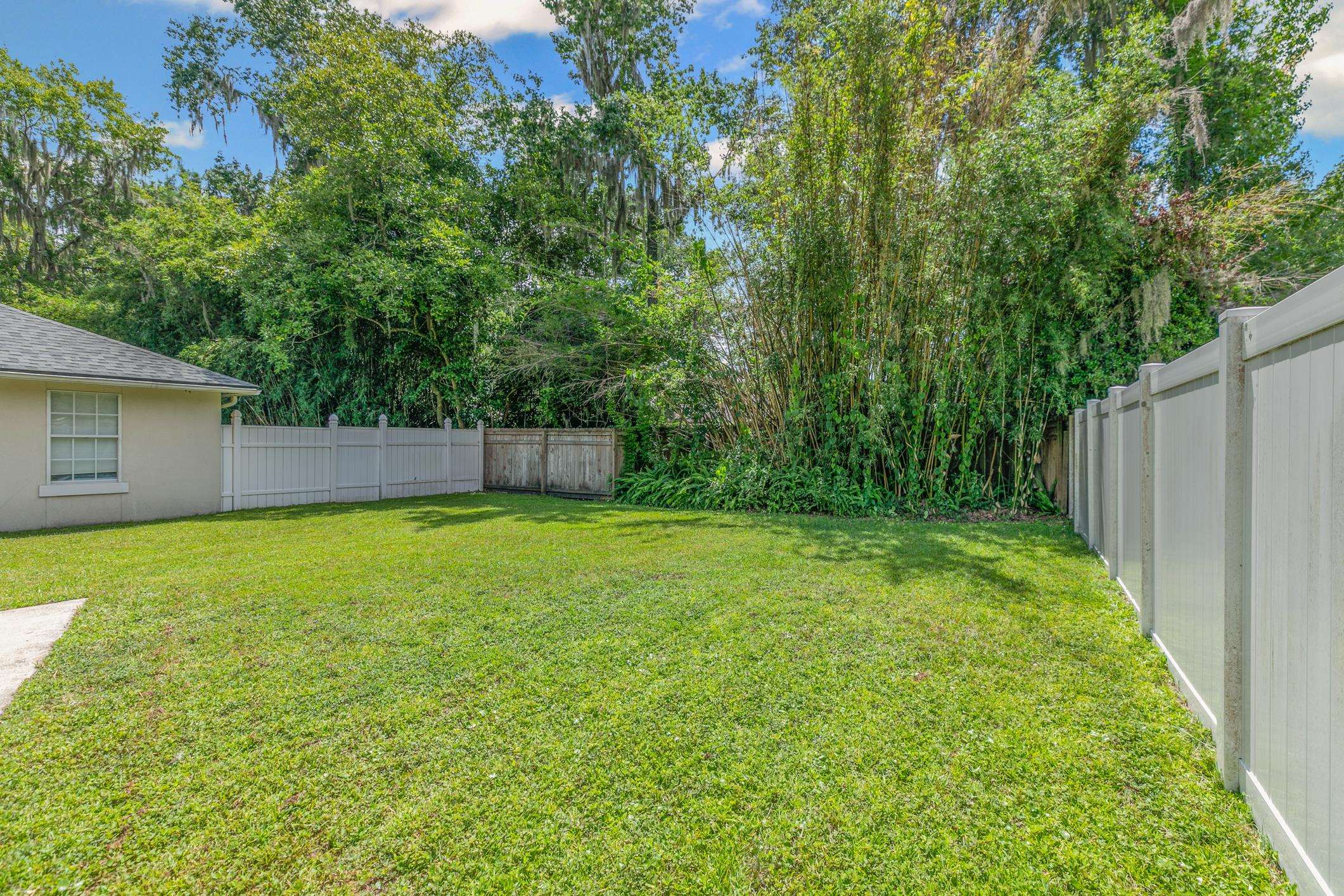 11511 Mandarin Road Jacksonville, FL 32223 - Photo 30 of 41 Fenced backyard with view of scattered trees