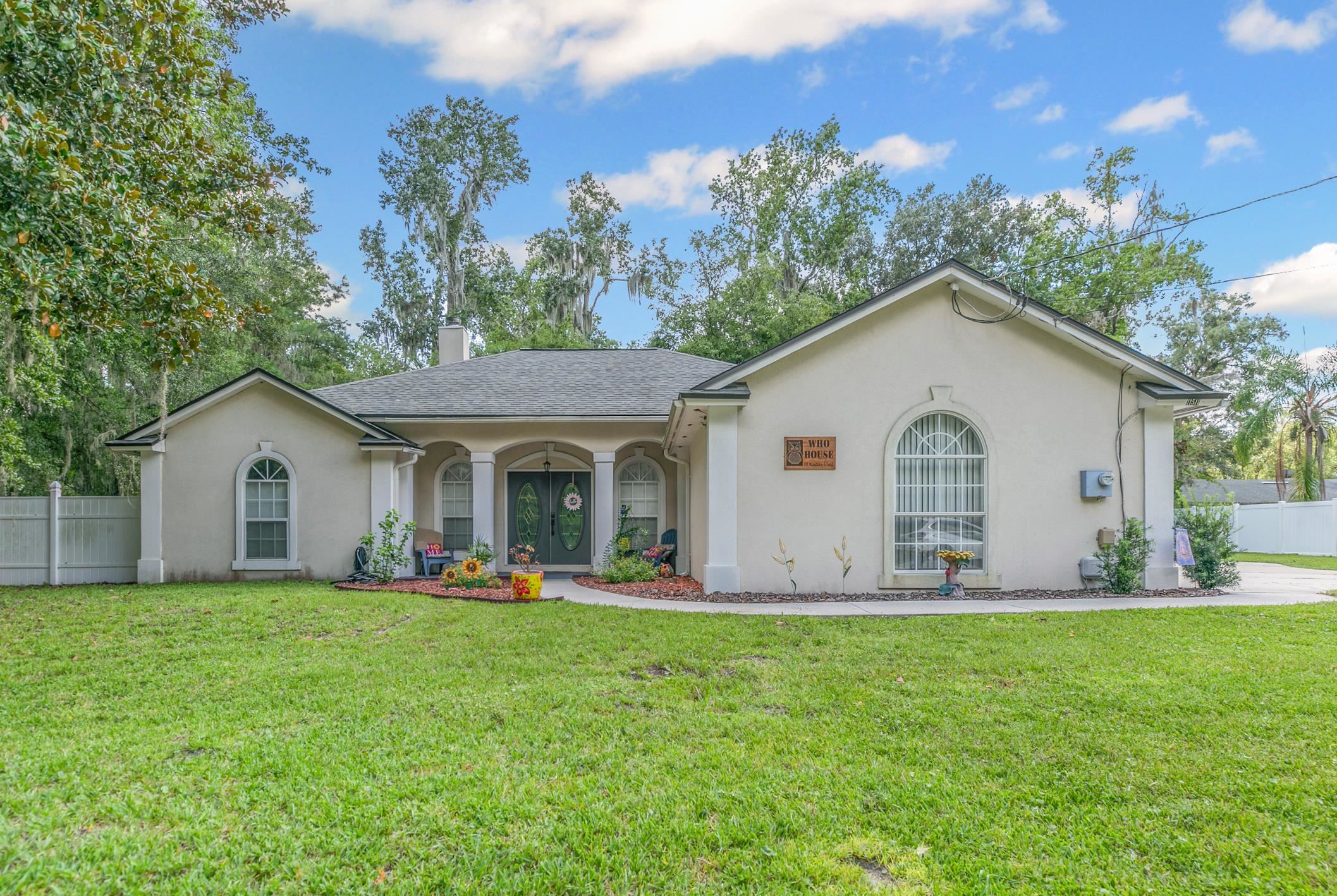 11511 Mandarin Road Jacksonville, FL 32223 - Photo 3 of 41 Single story home featuring stucco siding, a chimney, covered porch, and roof with shingles
