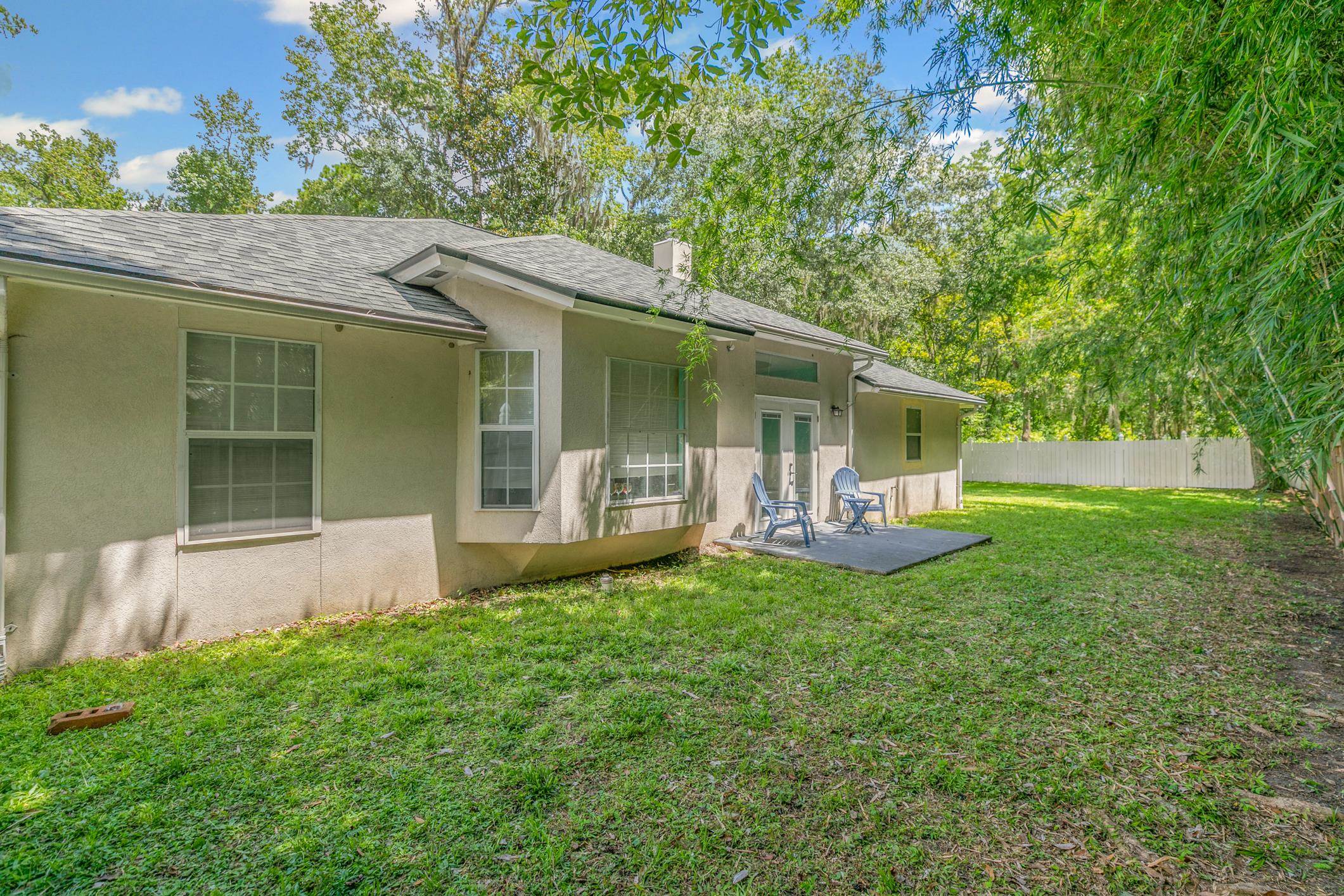 11511 Mandarin Road Jacksonville, FL 32223 - Photo 31 of 41 Back of property with stucco siding, roof with shingles, and french doors