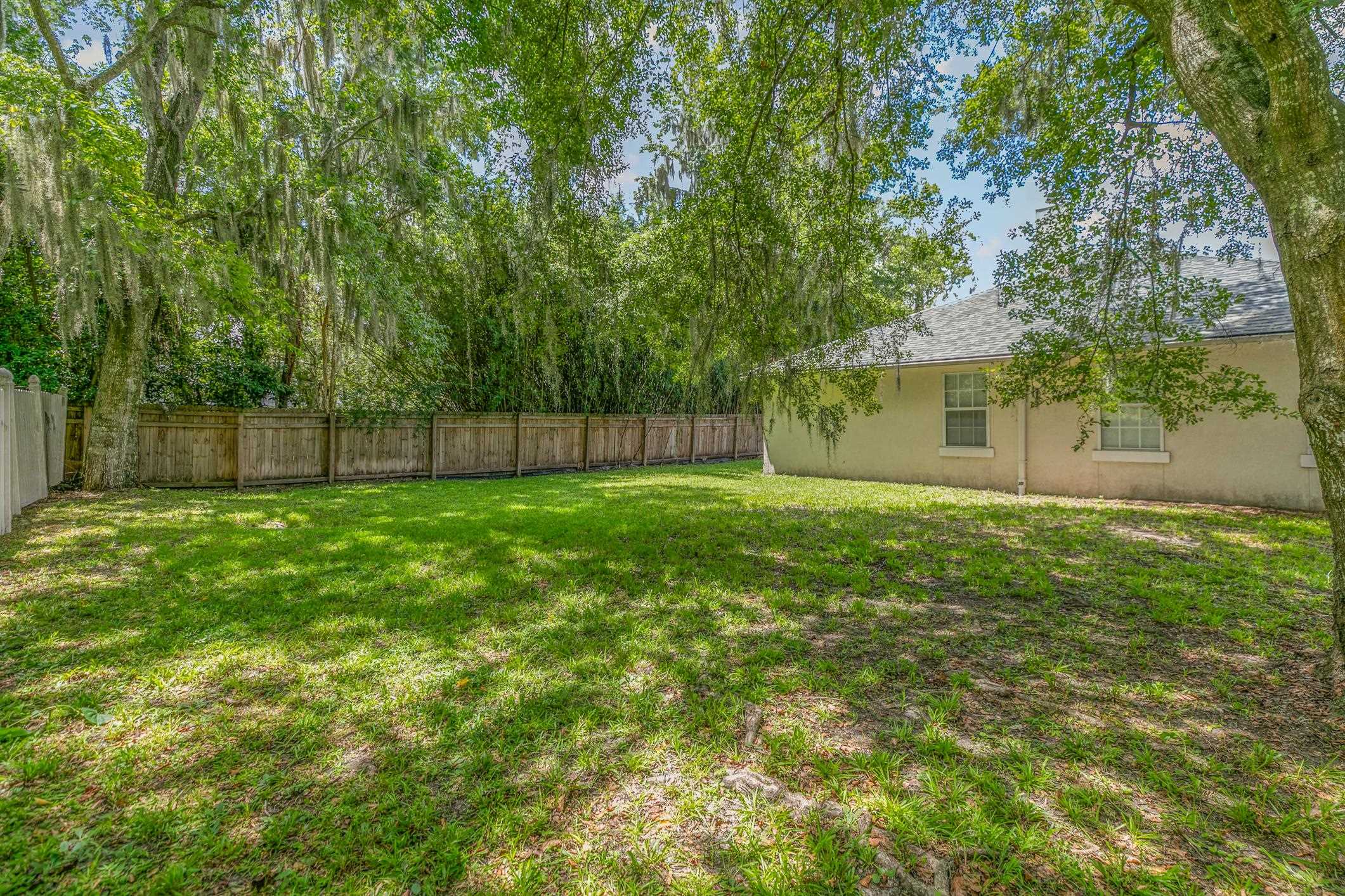 11511 Mandarin Road Jacksonville, FL 32223 - Photo 37 of 41 a view of a yard with a large tree and wooden fence