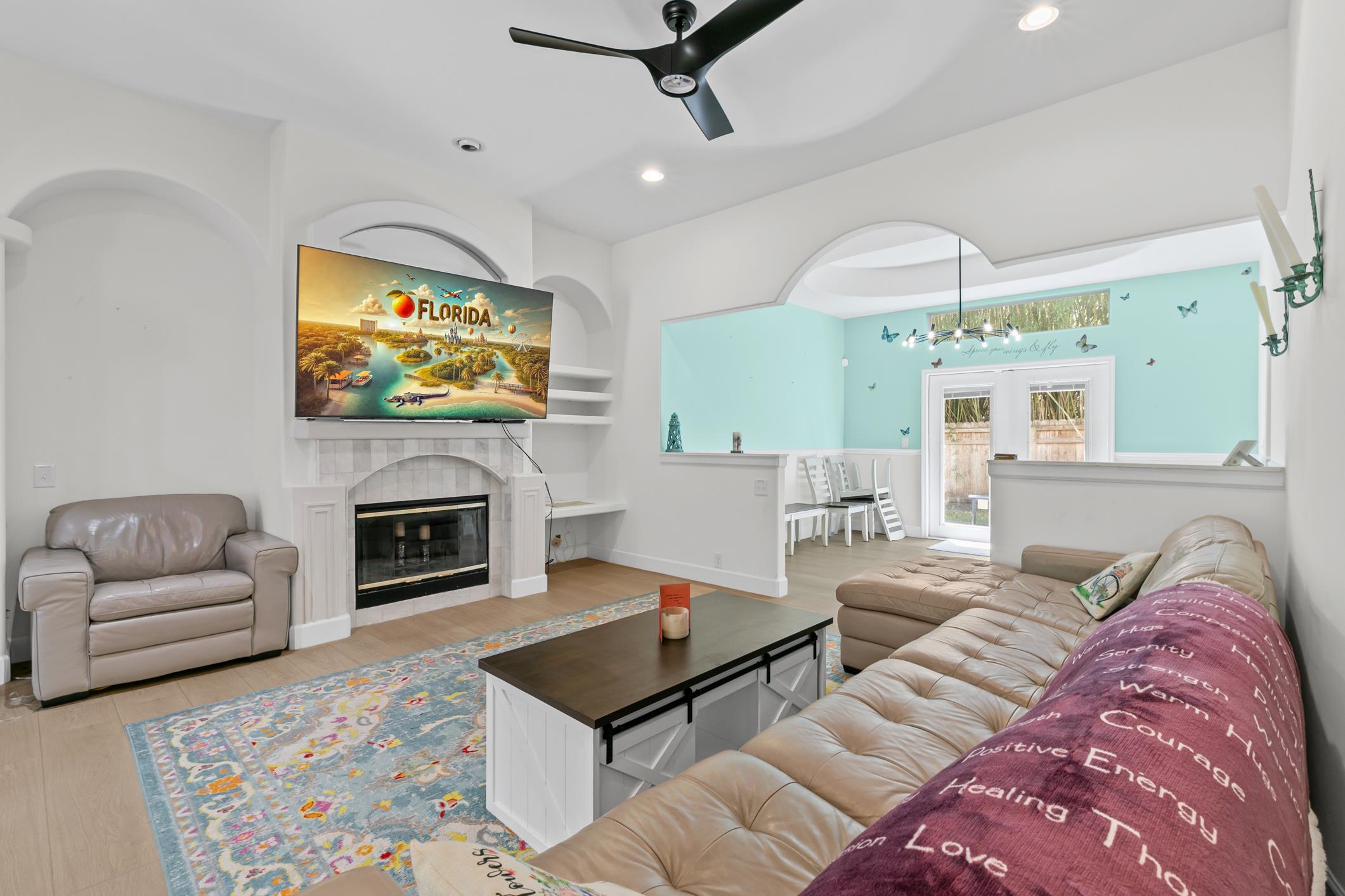 11511 Mandarin Road Jacksonville, FL 32223 - Photo 5 of 41 a living room with furniture a flat screen tv and a fireplace