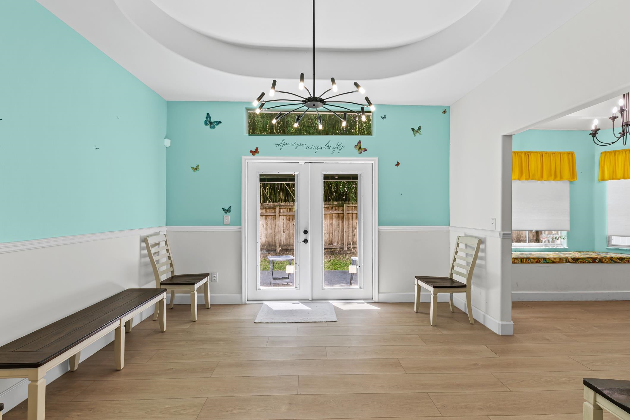 11511 Mandarin Road Jacksonville, FL 32223 - Photo 6 of 41 Formal dining room with a chandelier, light wood-style floors, a tray ceiling, and french doors