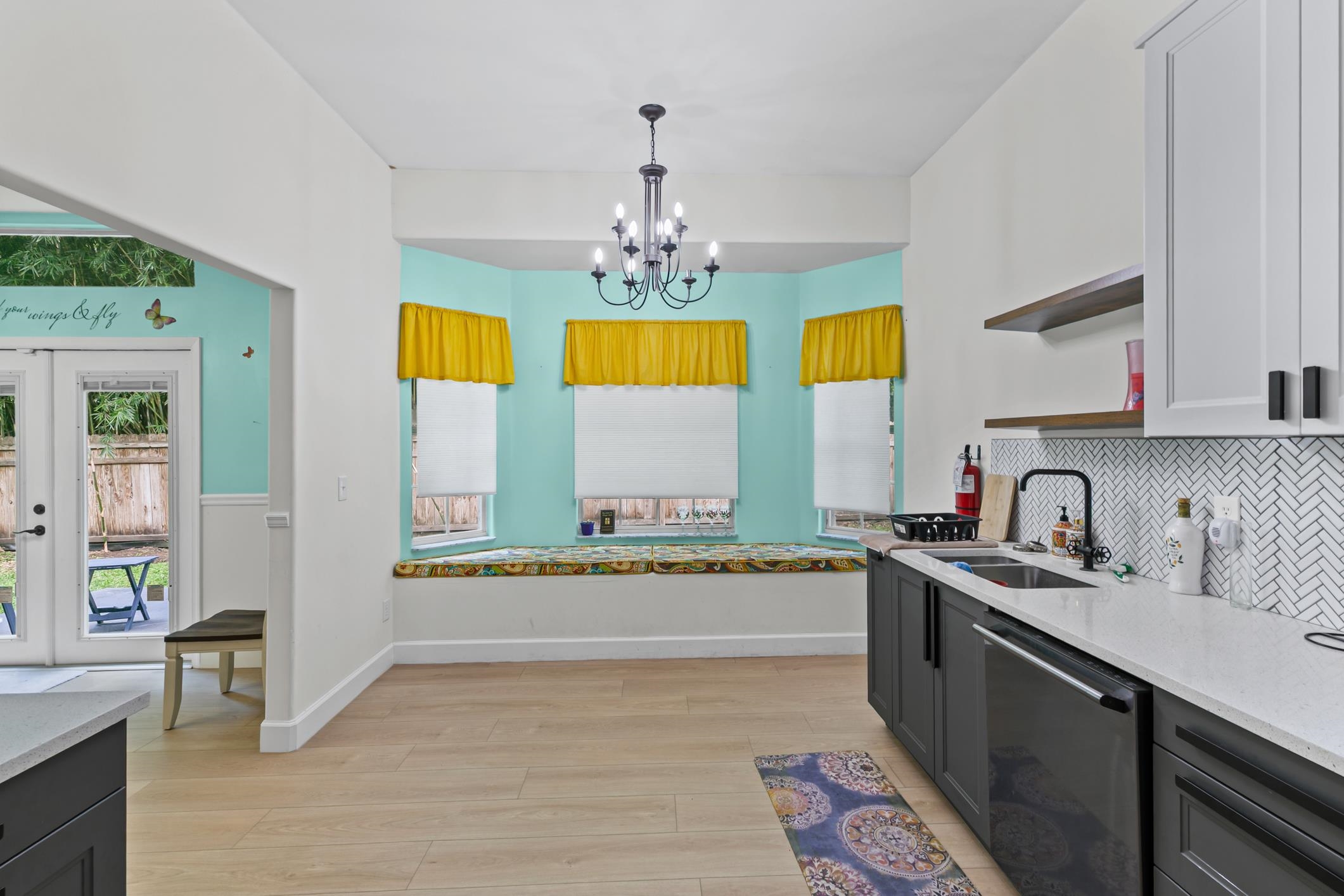11511 Mandarin Road Jacksonville, FL 32223 - Photo 10 of 41 Kitchen with light stone counters, dishwasher, open shelves, light wood-style flooring, and a chandelier