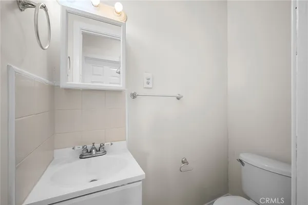 a bathroom with a sink toilet and vanity