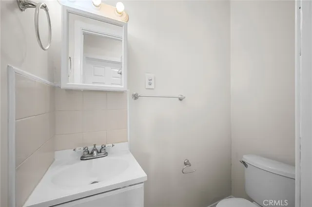 a bathroom with a sink toilet and vanity