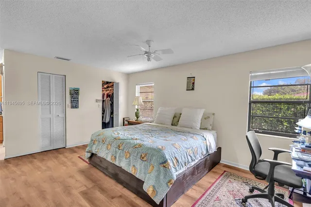 a bedroom with a bed a table and chair