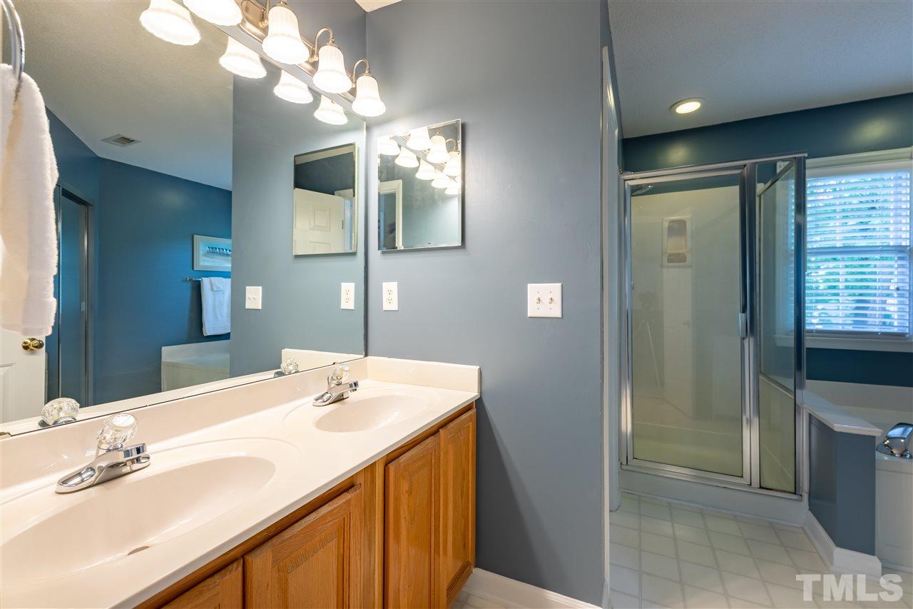 5304 Denmead Way Raleigh, NC 27613 - Photo 12 of 19 a bathroom with a sink a vanity and a mirror