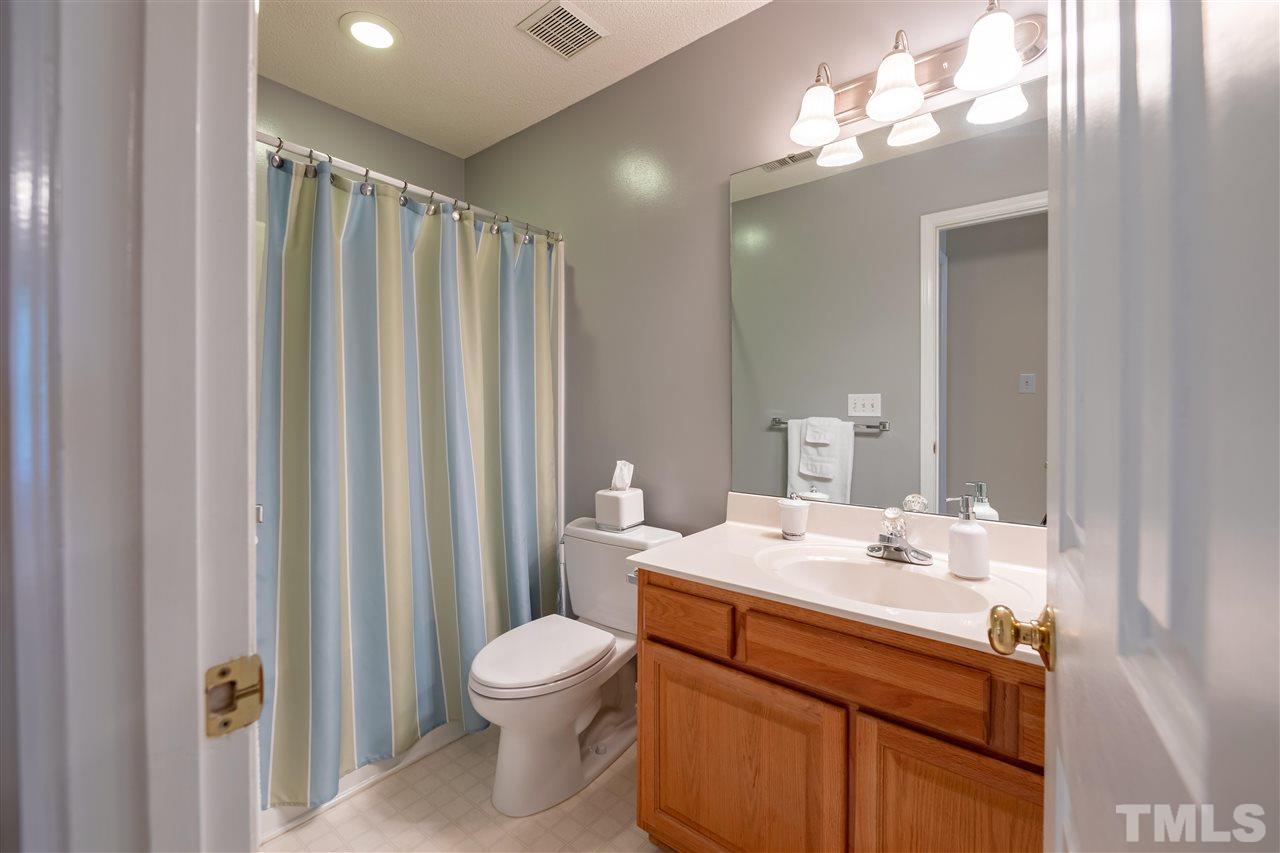5304 Denmead Way Raleigh, NC 27613 - Photo 15 of 19 a bathroom with a sink a toilet and shower