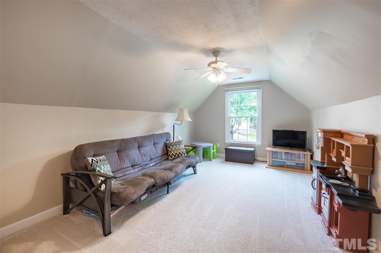 5304 Denmead Way Raleigh, NC 27613 - Photo 16 of 19 a living room with furniture a window and a flat screen tv