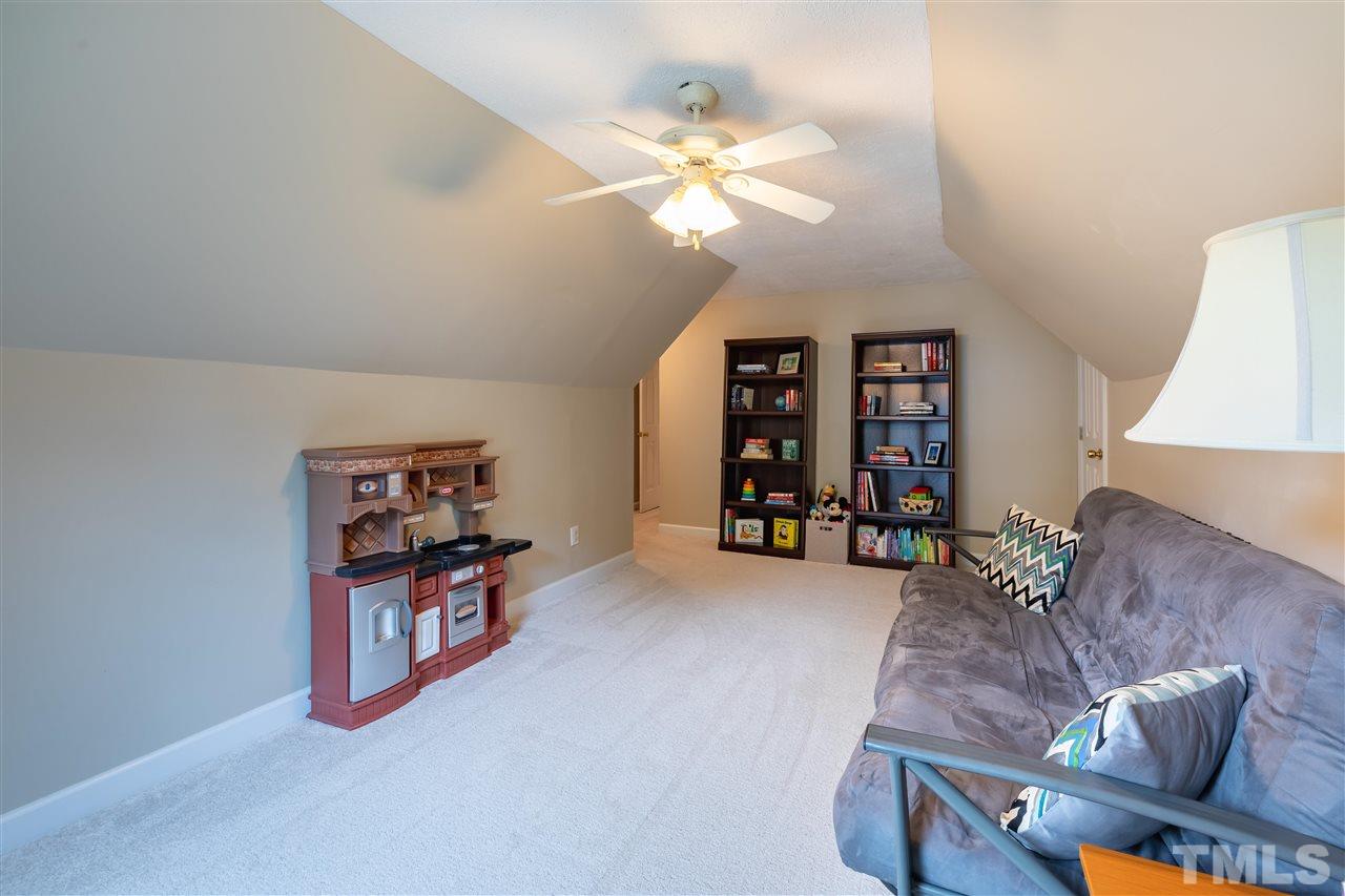 5304 Denmead Way Raleigh, NC 27613 - Photo 17 of 19 a living room with furniture and a chandelier
