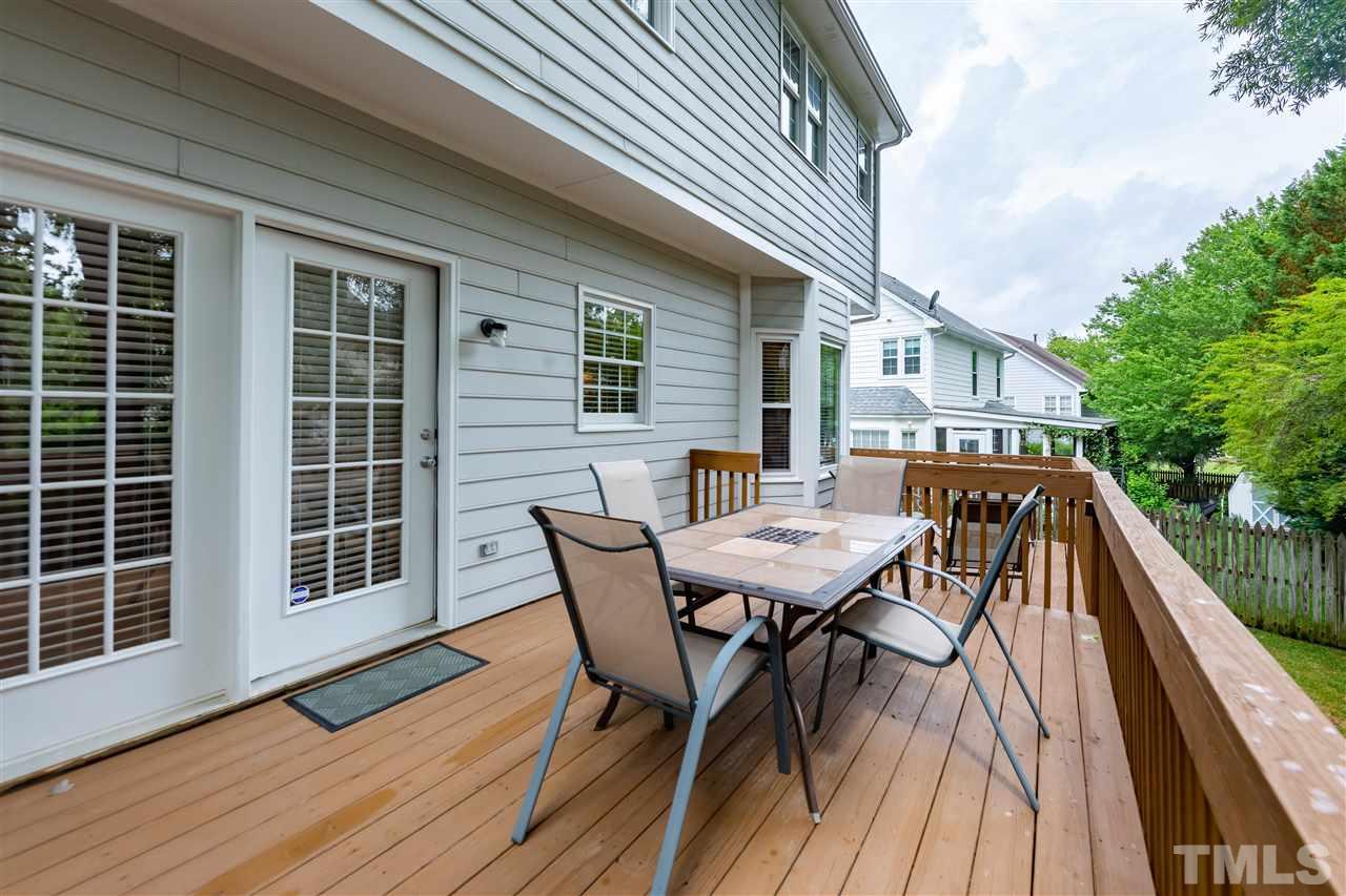 5304 Denmead Way Raleigh, NC 27613 - Photo 19 of 19 a view of a roof deck with table and chairs and wooden floor