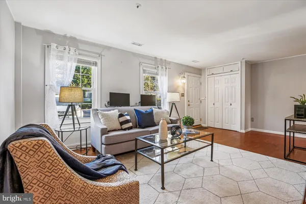 a living room with furniture and a potted plant