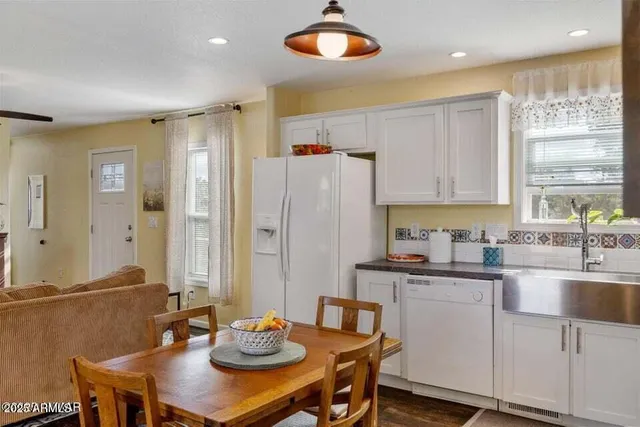 a kitchen with stainless steel appliances kitchen island granite countertop a sink and cabinets