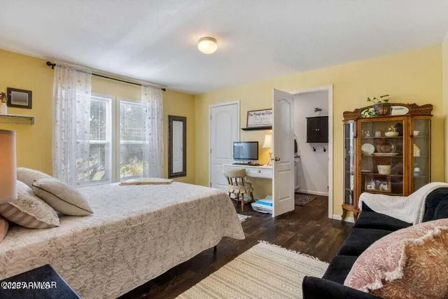 a bedroom with a bed a couch and dresser