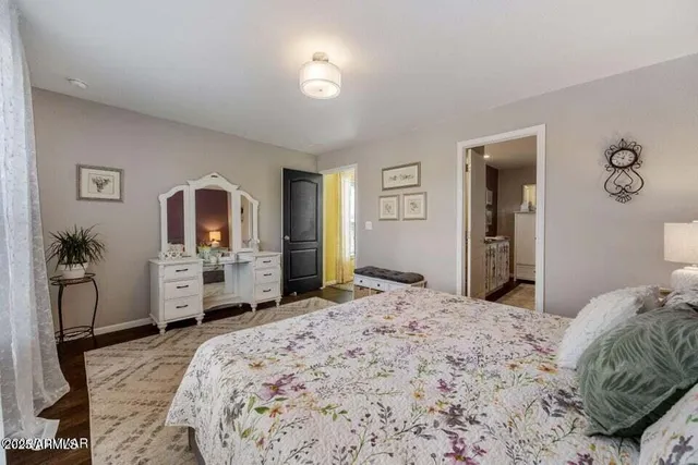 a bedroom with a large bed and dresser