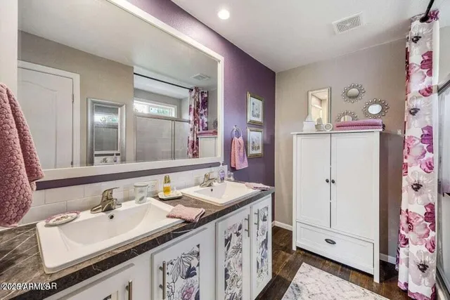 a bathroom with a sink double vanity and a mirror