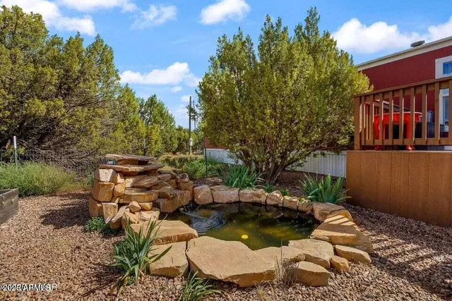 a backyard of a house with yard basket ball court and outdoor seating