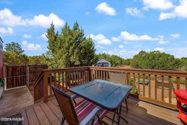 a view of a balcony with wooden floor and fence
