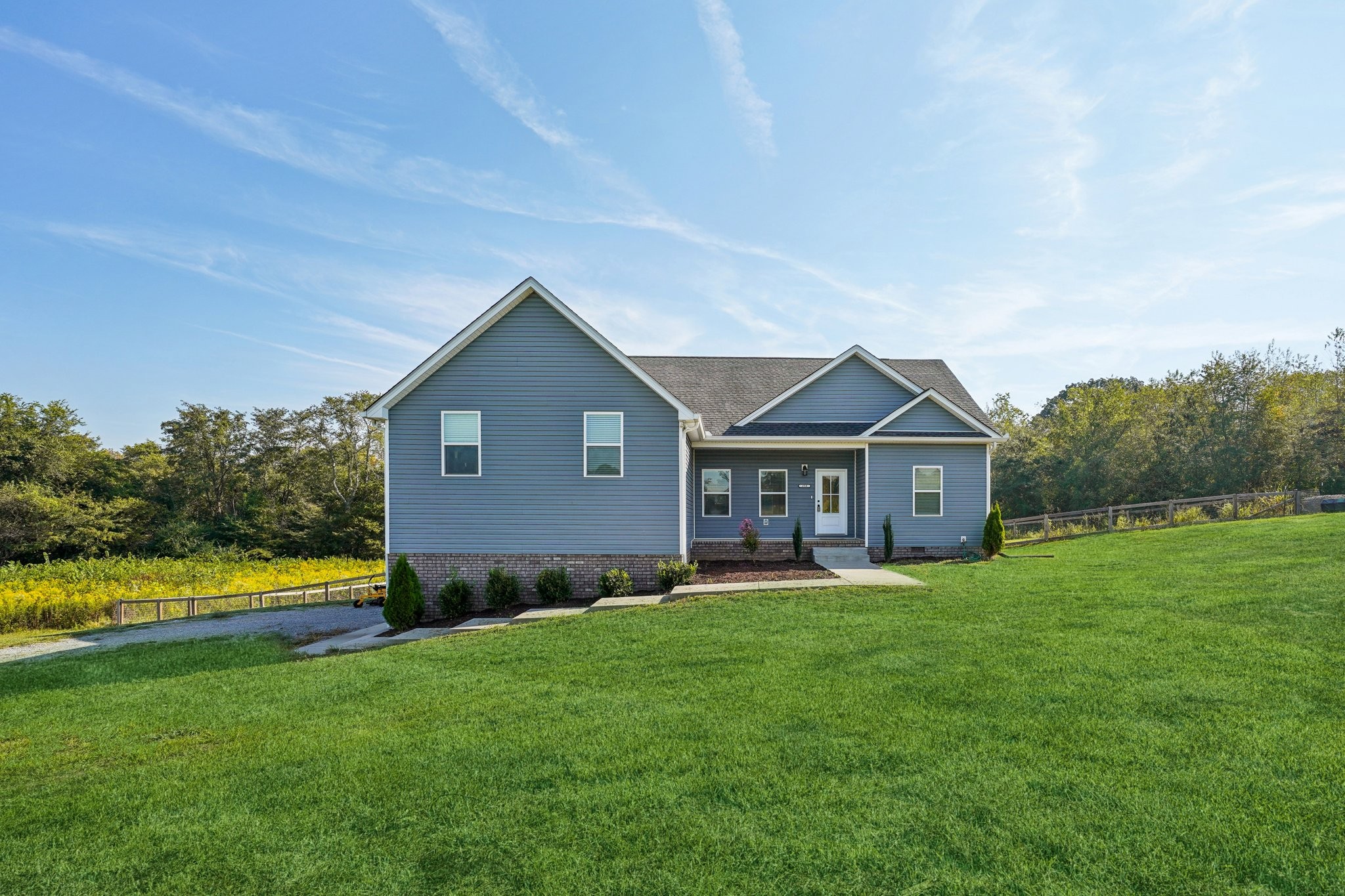 258 Woodruff Road Adams, TN 37010 - Photo 6 of 49 a front view of a house with garden