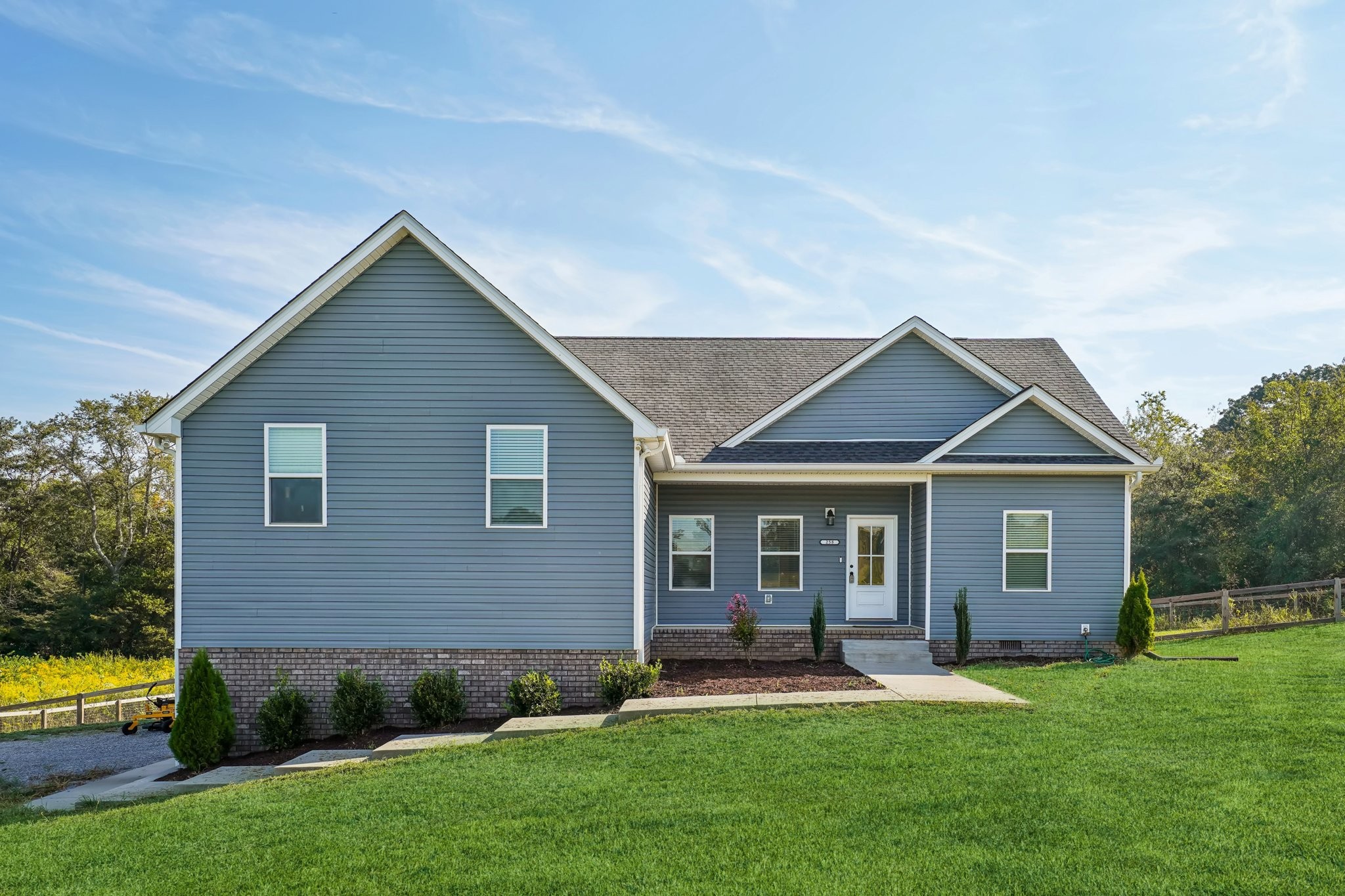 258 Woodruff Road Adams, TN 37010 - Photo 8 of 49 a front view of a house with a yard and green space