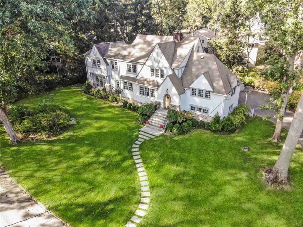 a aerial view of residential houses with yard and trees