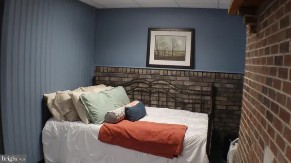 a bedroom with a bed and the window
